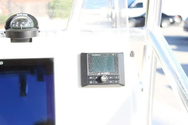 Slide: The Image of 2024 Pathfinder 2200 TRS boat console with compass and JL Audio system. - 14