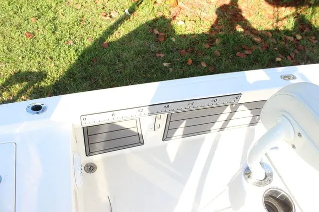 Slide: The Image of 2024 Pathfinder 2200 TRS boat with measuring scale and seating area. - 16