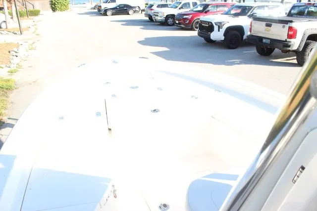 Slide: The Image of 2024 Pathfinder 2200 TRS boat on parking lot with cars in background. - 20