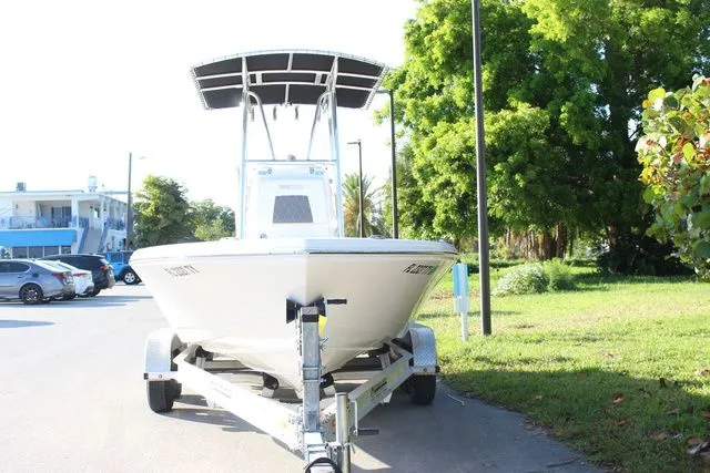 Slide: The Image of 2024 Pathfinder 2200 TRS boat on trailer, parked outdoors. - 3