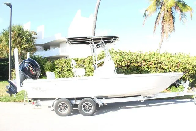 Slide: The Image of 2024 Pathfinder 2200 TRS boat on trailer, sunny day, palm trees in background. - 4