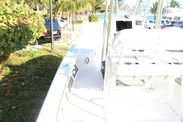 Slide: The Image of 2024 Pathfinder 2200 TRS boat docked with tropical background. - 9