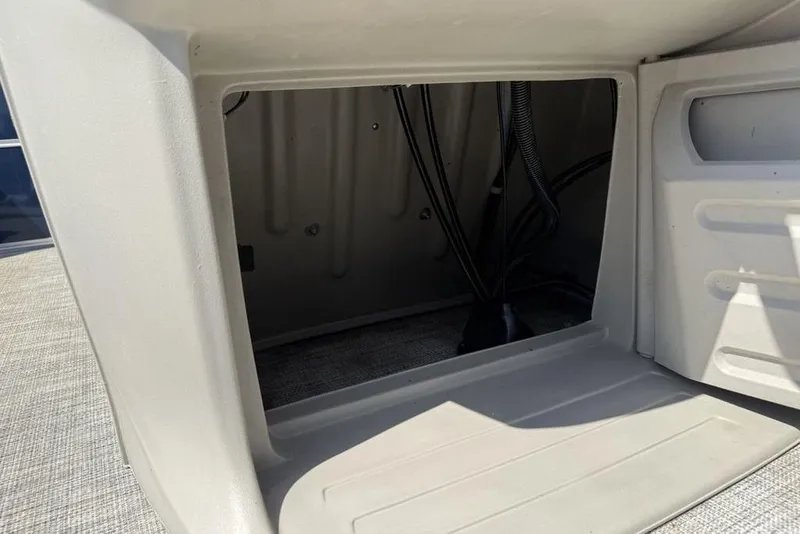 Slide: The Image of Steering wheel and dashboard of 2022 Berkshire 24RFX LE boat, featuring gauges and controls. - 11