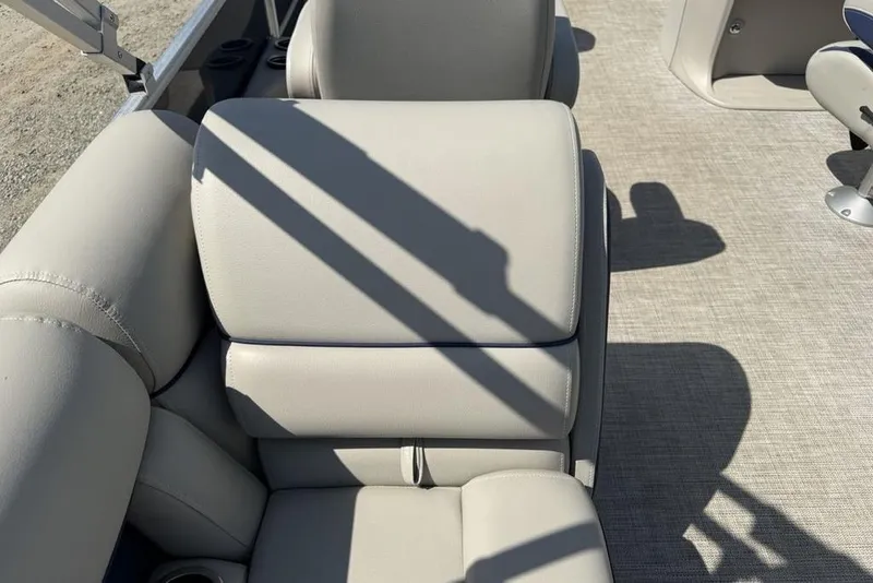 Slide: The Image of 2022 Berkshire 24RFX LE pontoon boat interior with plush seating and steering console. - 19