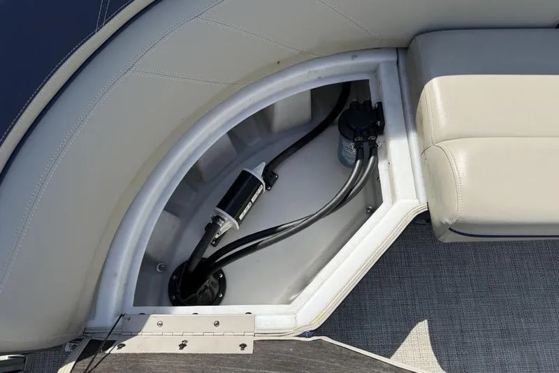 Slide: The Image of 2022 Berkshire 24RFX LE pontoon boat interior with beige and navy seating. - 20