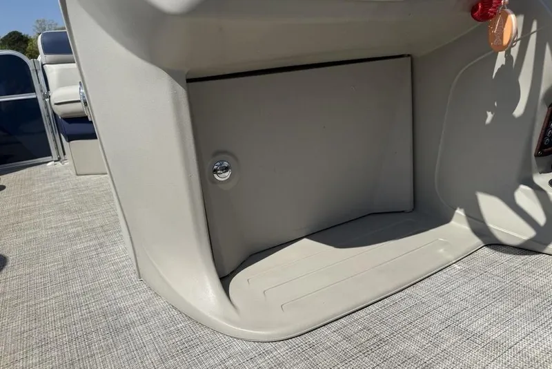 Slide: The Image of 2022 Berkshire 24RFX LE boat interior storage compartment with textured flooring. - 25