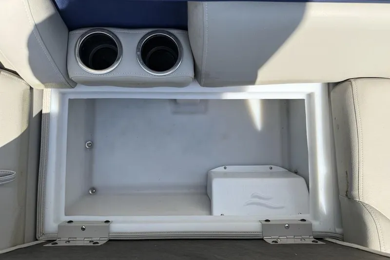 Slide: The Image of Storage compartment with cup holders in 2022 Berkshire 24RFX LE boat. - 26