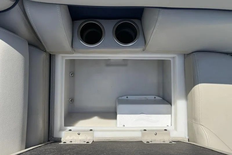 Slide: The Image of Interior storage compartment with cup holders in a 2022 Berkshire 24RFX LE boat. - 30