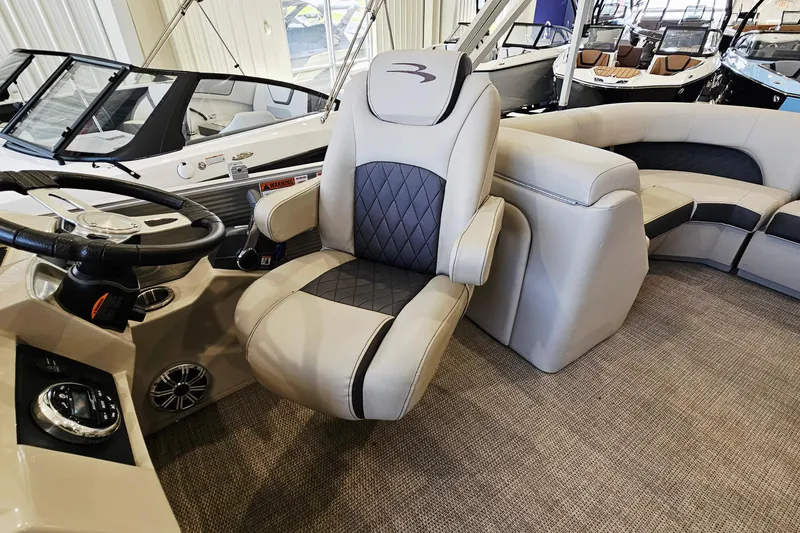 Slide: The Image of 2019 Bennington SX 22 Premium Stern Radius boat interior with luxurious seating and steering wheel. - 10