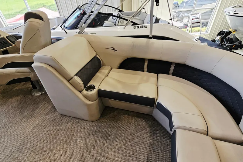 Slide: The Image of 2019 Bennington SX 22 Premium Stern Radius boat interior with plush seating and cup holder. - 13
