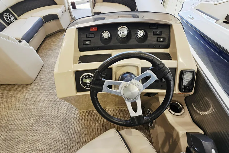 Slide: The Image of 2019 Bennington SX 22 Premium boat interior with steering wheel and dashboard controls. - 14