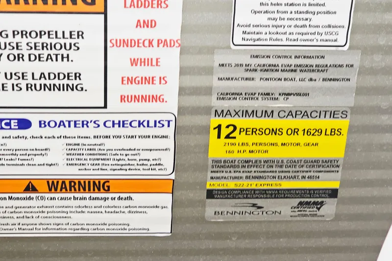 Slide: The Image of Warning and capacity labels on a 2019 Bennington SX 22 Premium Stern Radius boat. - 16