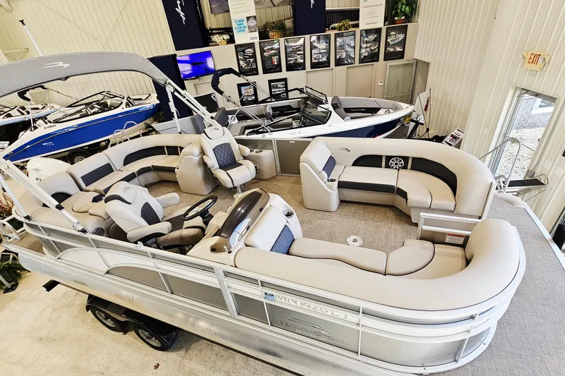 Slide: The Image of 2019 Bennington SX 22 Premium Stern Radius pontoon boat with luxurious seating in showroom. - 3