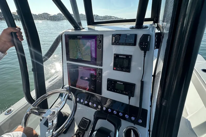 Slide: The Image of 2023 Latitude Tournament Boats LTB 25 deck area with storage compartment, outdoor setting. - 14