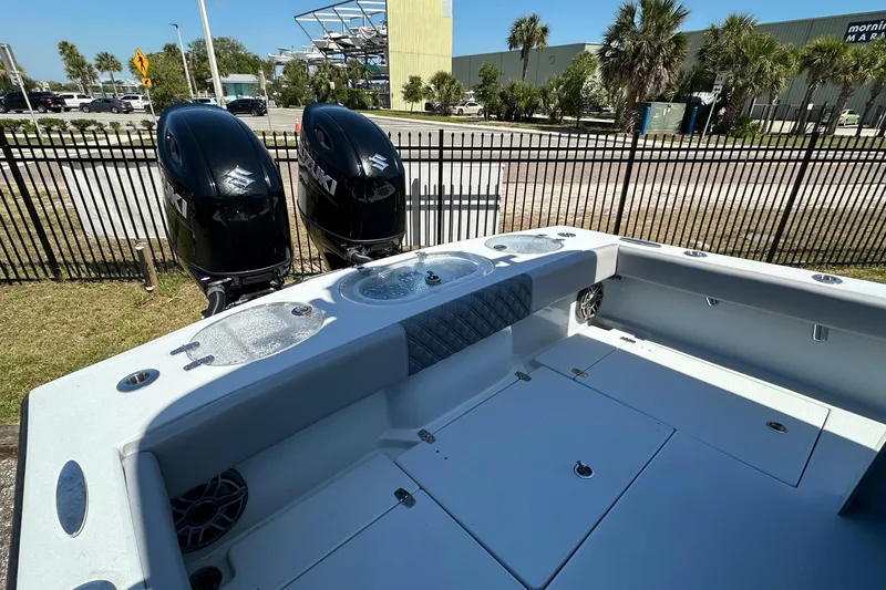 Slide: The Image of 2023 Latitude Tournament Boats LTB 25 helm with Simrad electronics, parked outdoors. - 16