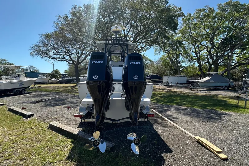 Slide: The Image of 2023 Latitude Tournament Boats LTB 25 with dual 200 horsepower engines in a sunny outdoor setting. - 18