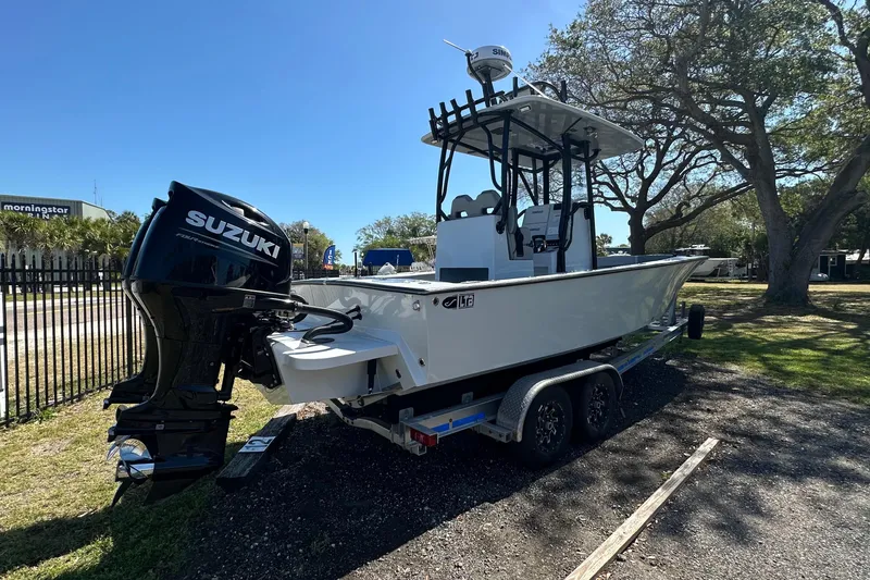 Slide: The Image of 2023 Latitude Tournament Boats LTB 25 on trailer under clear blue sky. - 3