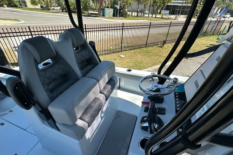 Slide: The Image of 2023 Latitude Tournament Boats LTB 25 on trailer, parked outdoors under clear blue sky. - 7