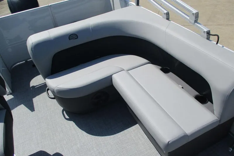 Slide: The Image of 2026 Sun Tracker Party Barge 18 DLX interior seating with gray upholstery and cup holders. - 12