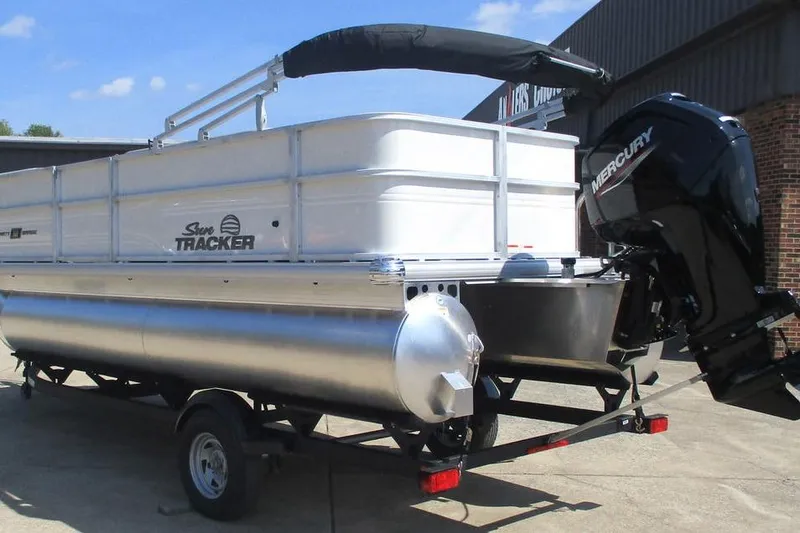 Slide: The Image of 2026 Sun Tracker Party Barge 18 DLX pontoon boat with Mercury outboard motor on trailer. - 5