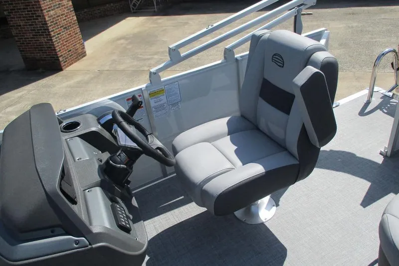 Slide: The Image of 2026 Sun Tracker Party Barge 18 DLX helm with comfortable captain's chair and steering console. - 8