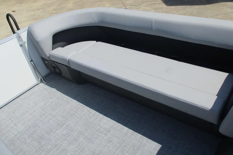 Slide: The Image of 2026 Sun Tracker Party Barge 18 DLX interior with gray seating and flooring. - 9