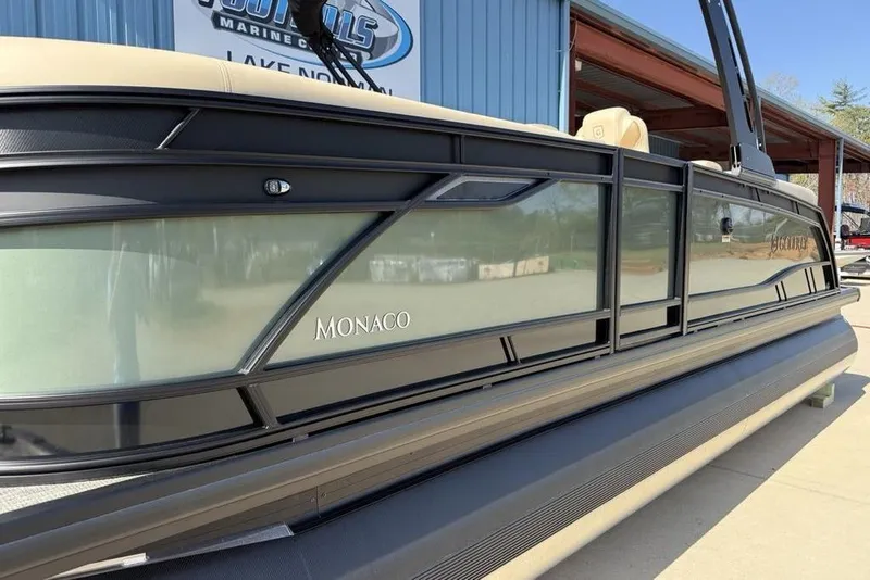 Slide: The Image of 2026 Godfrey Monaco 235 SB pontoon boat at a marina. - 3
