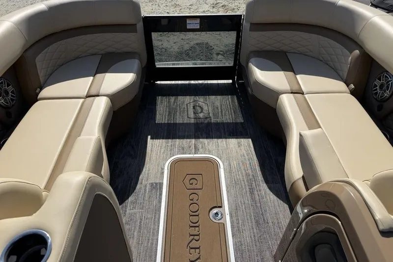 Slide: The Image of Luxurious interior of 2026 Godfrey Monaco 235 SB pontoon boat with beige seating. - 4