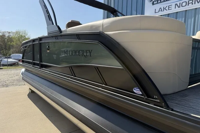 Slide: The Image of 2026 Godfrey Monaco 235 SB pontoon boat, sleek design, displayed outdoors near Lake Norman. - 5