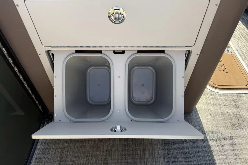 Slide: The Image of Storage compartment with dual bins on a 2026 Godfrey Monaco 235 SB boat. - 6