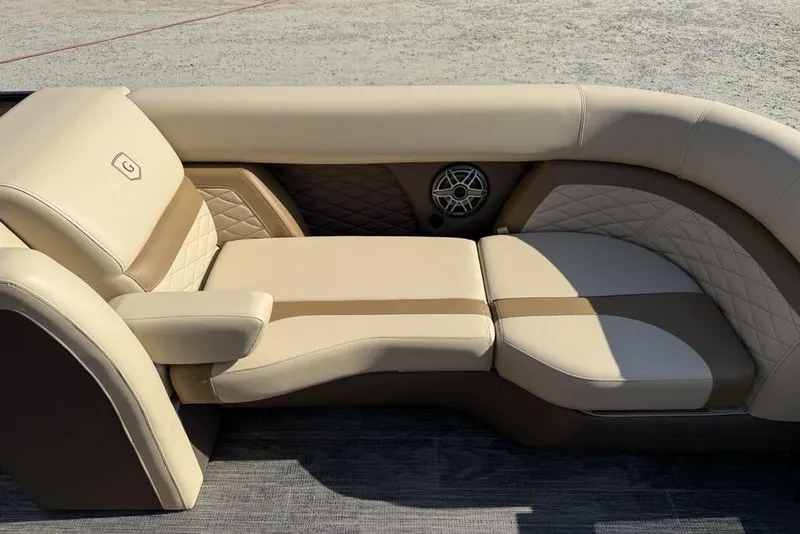 Slide: The Image of Luxurious seating on 2026 Godfrey Monaco 235 SB boat, featuring beige upholstery and quilted accents. - 9