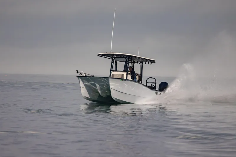 Slide: The Image of A 2026 Calcutta 263 boat cruising on calm waters under a cloudy sky. - 10
