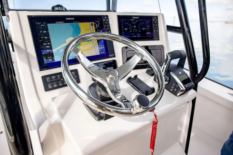 Slide: The Image of Helm of 2026 Calcutta 263 boat with advanced navigation displays and controls. - 12