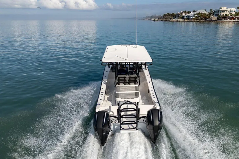 Slide: The Image of 2026 Calcutta 263 boat cruising on calm waters near coastal homes. - 15