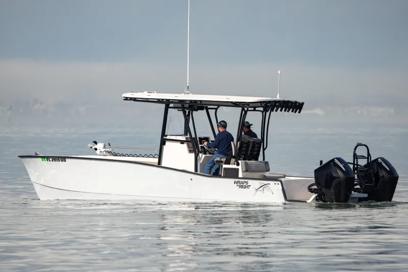 Slide: The Image of A 2026 Calcutta 263 boat with dual engines cruising on calm waters. - 4