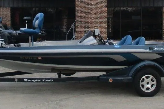 The Image of 2007 Ranger 188VS Intracoastal boat on trailer, blue seats, parked outside brick building. - 1