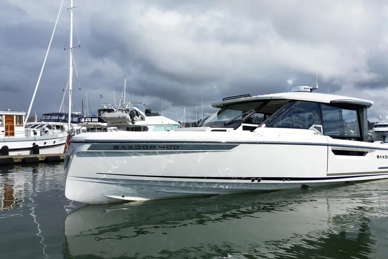 The Image of 2026 Saxdor 400 GTC boat docked in a marina under cloudy skies. - 0