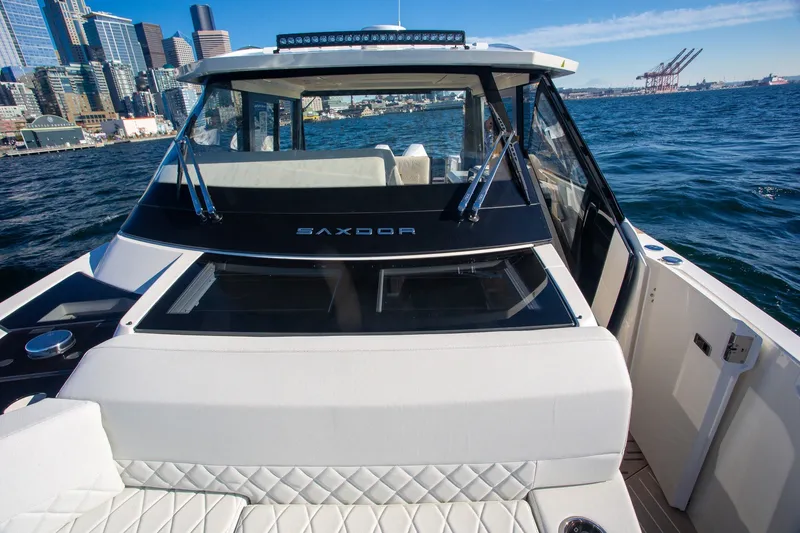 Slide: The Image of 2026 Saxdor 400 GTC yacht cruising near city skyline and harbor cranes. - 32
