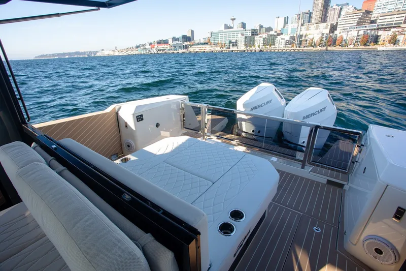 Slide: The Image of 2026 Saxdor 400 GTC luxury boat with twin Mercury engines, docked near city skyline. - 35