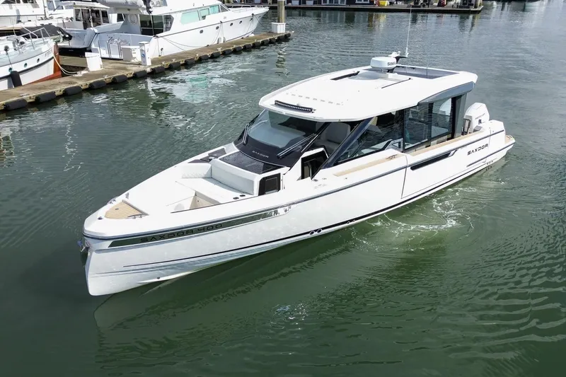 Slide: The Image of 2026 Saxdor 400 GTC luxury boat docked in a marina, showcasing sleek design and modern features. - 4