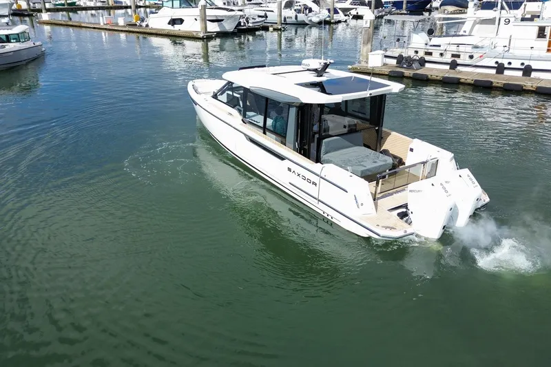 Slide: The Image of 2026 Saxdor 400 GTC luxury boat cruising in a marina. - 5