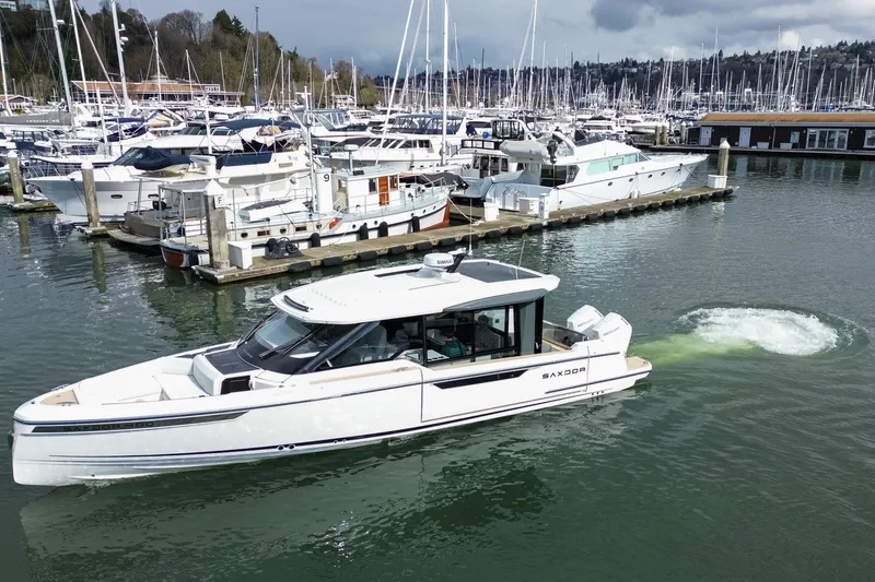 Slide: The Image of 2026 Saxdor 400 GTC yacht docked in a marina with surrounding boats. - 8