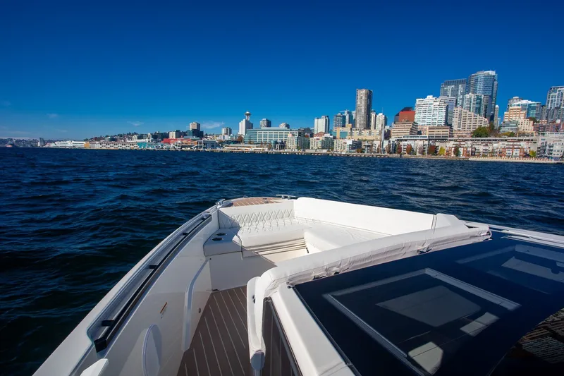 Slide: The Image of Saxdor 400 GTC boat cruising near a city skyline, 2026 model. - 31
