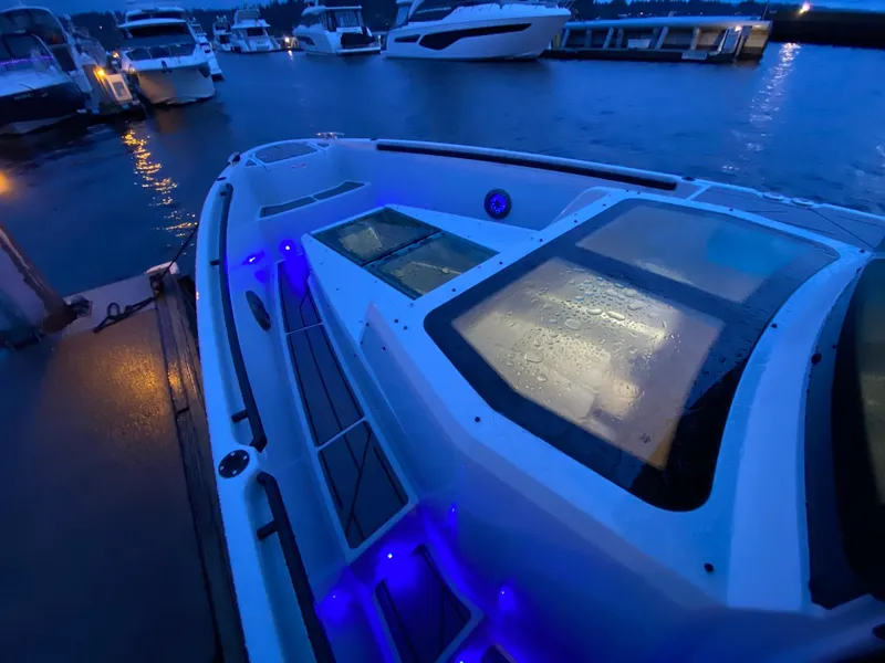 Slide: The Image of Saxdor 320 GTC 2025 model docked at marina with blue LED lights. - 10