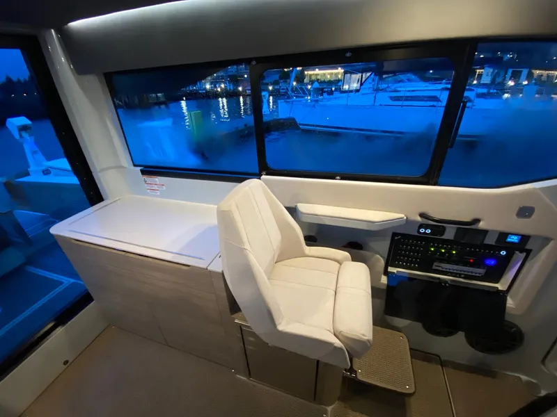 Slide: The Image of Interior helm station of 2025 Saxdor 320 GTC with modern controls and waterfront view. - 14