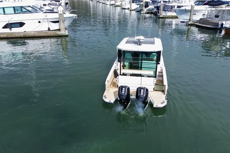 Slide: The Image of 2026 Saxdor 320 GTC boat with dual engines in a marina setting. - 27