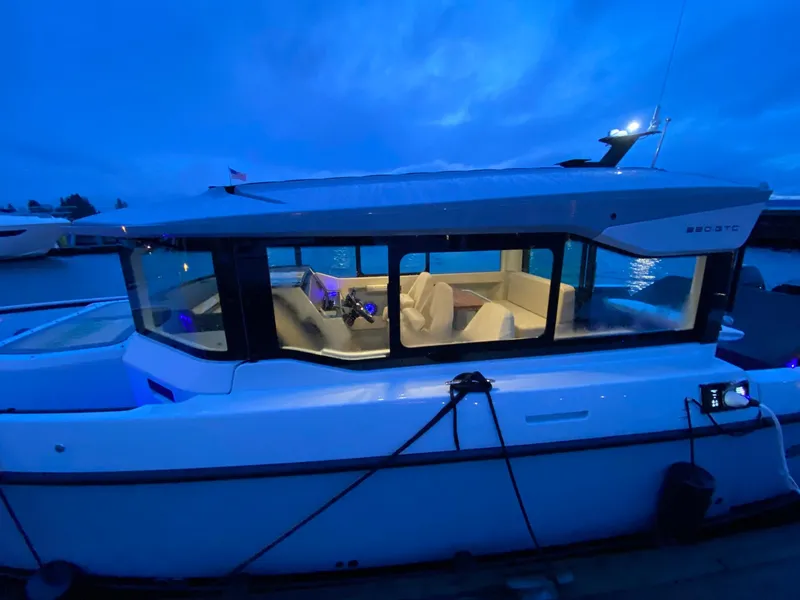 Slide: The Image of 2025 Saxdor 320 GTC boat docked at night with illuminated interior. - 7