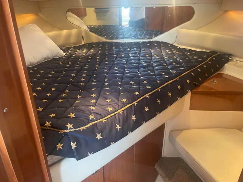 Slide: The Image of Interior of a 2005 Regal 3560 Express with star-patterned bedding. - 15