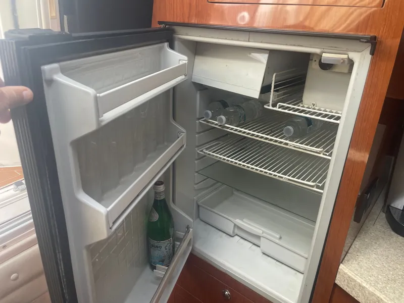 Slide: The Image of Open fridge in a 2005 Regal 3560 Express yacht. - 21