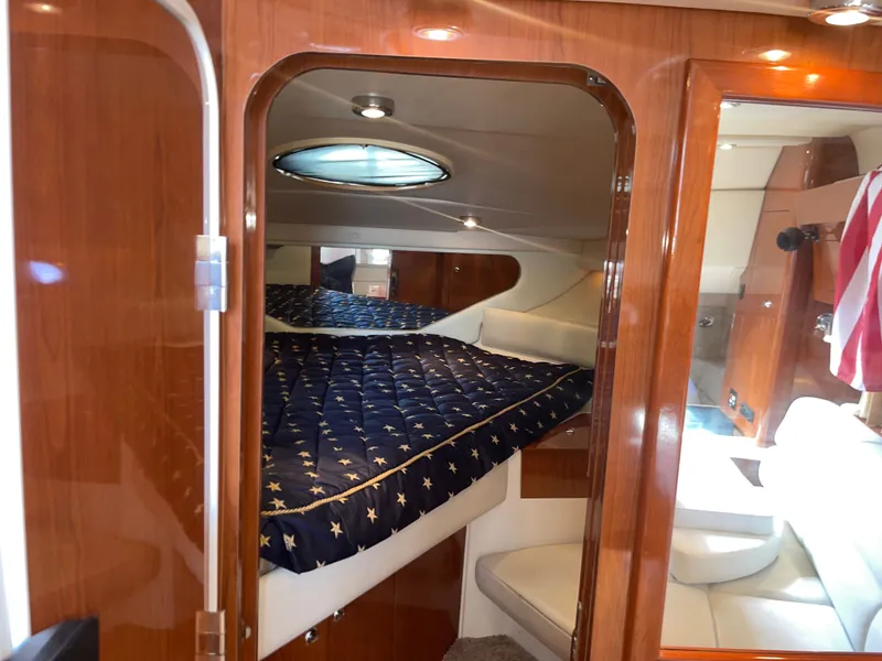 Slide: The Image of Interior of 2005 Regal 3560 Express yacht featuring a luxurious bedroom. - 26